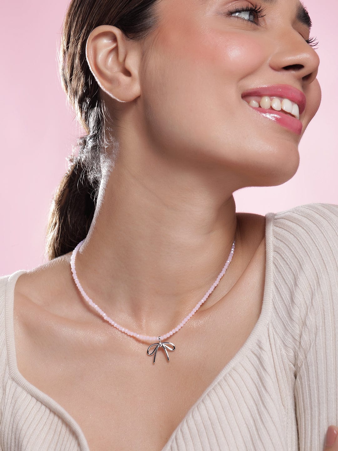 Rhodium Plated Soft Pink Beaded Necklace with Silver Bow Pendant