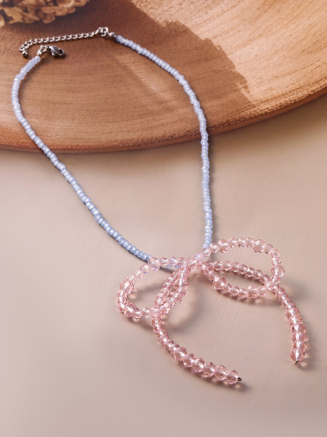 Rubans Rhodium Plated Blue Beaded Necklace with Pink Crystal Bow Pendant