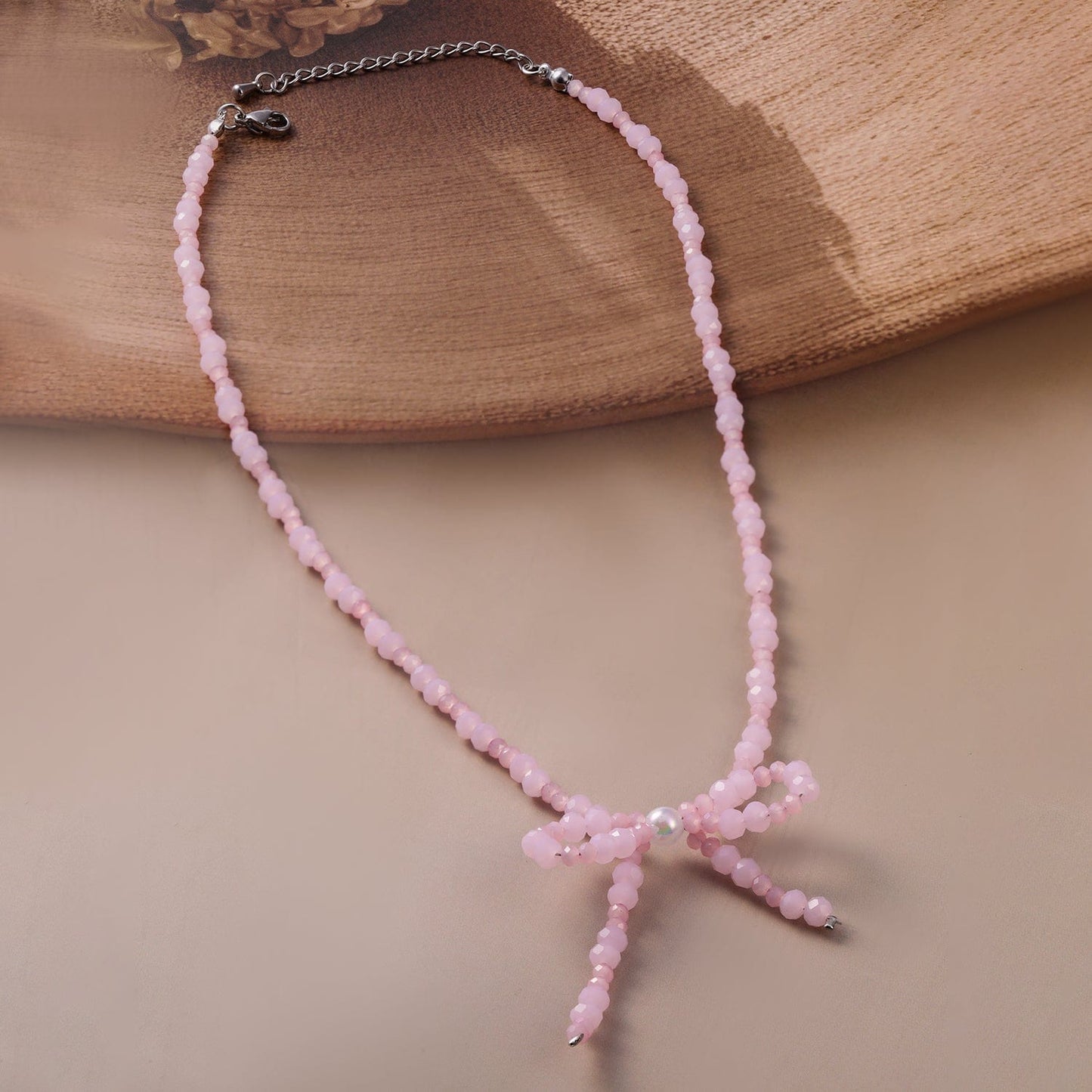 Rhodium Plated Pink Bead Necklace with Bow Pendant