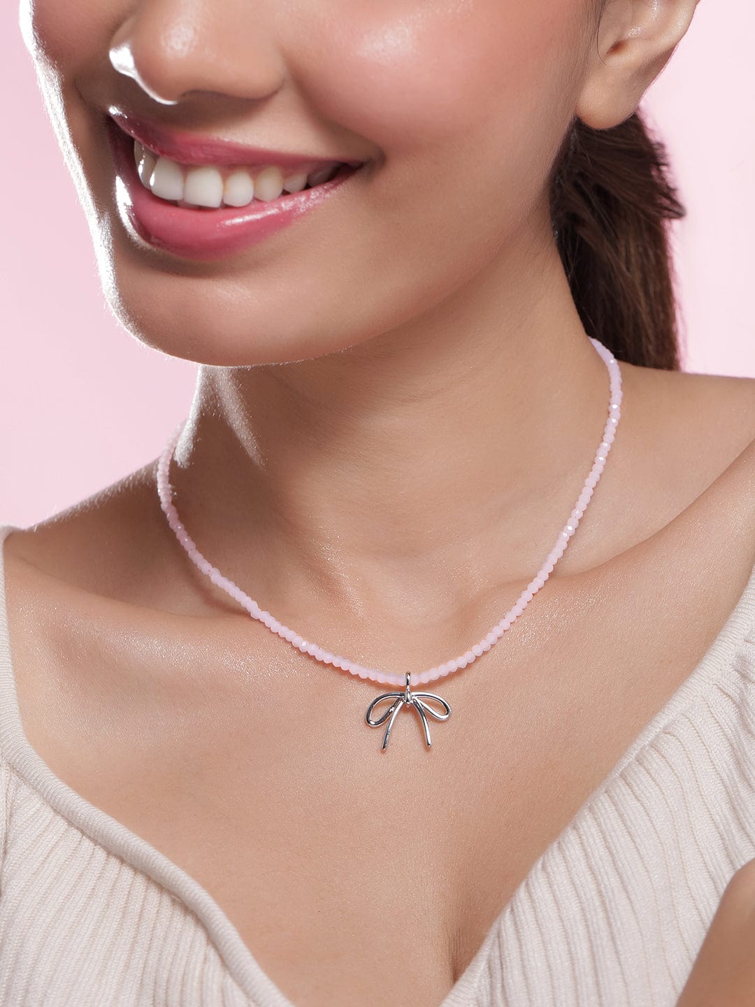 Rhodium Plated Soft Pink Beaded Necklace with Silver Bow Pendant