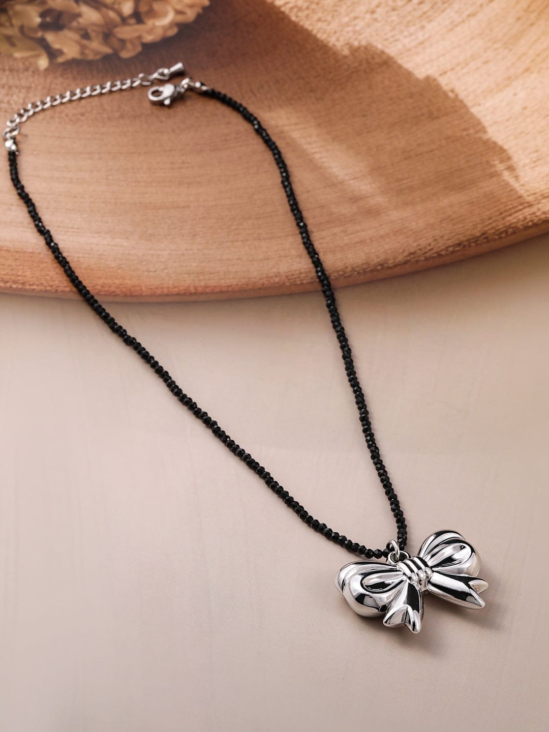 Rubans Voguish Rubans Rhodium Plated Black Beaded Necklace with Silver Bow Pendant