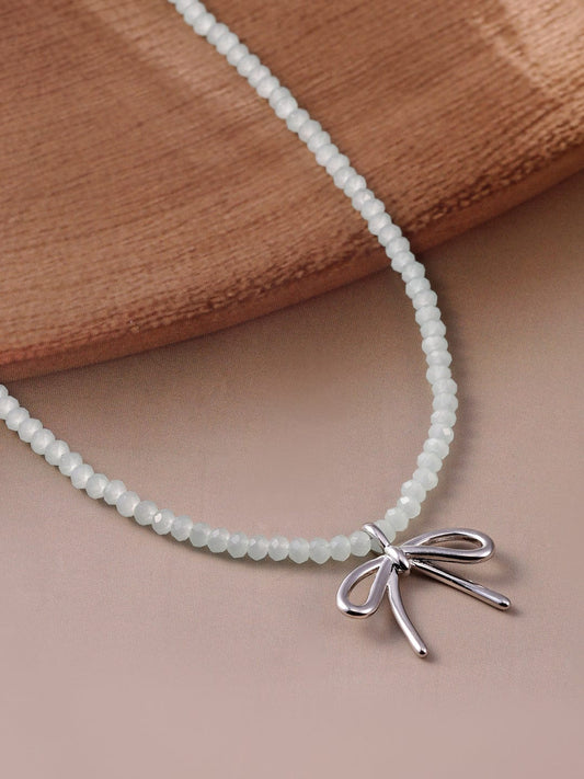 Rubans Rhodium Plated Minimalist White Beaded Necklace with Silver Bow Charm
